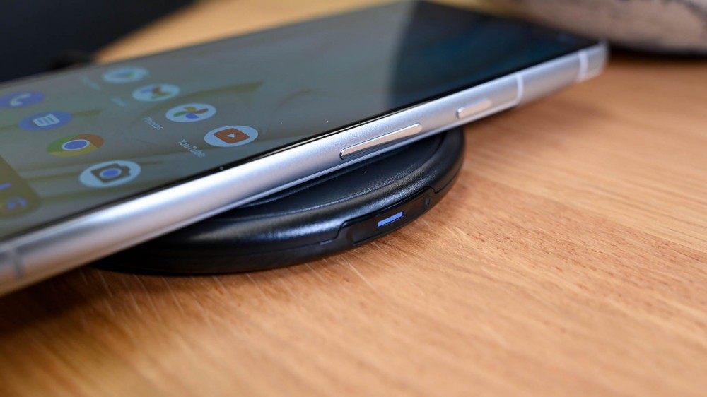 The Otterbox Wireless Charging Pad charging an iPhone.